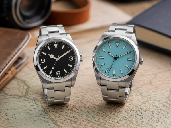 Expedition-style and minimalist steel everyday watches on a travel desk