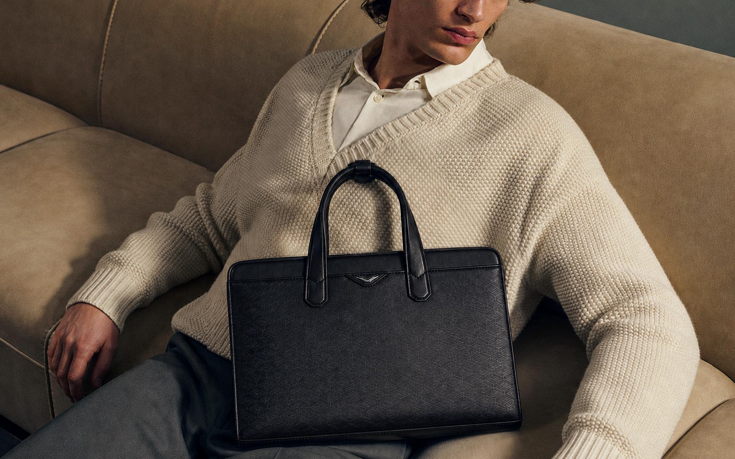 A luxury crossbody bag with a distinctive design and chain strap.