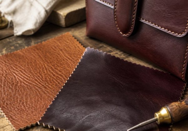 Leather grain and edge construction beside a luxury accessory