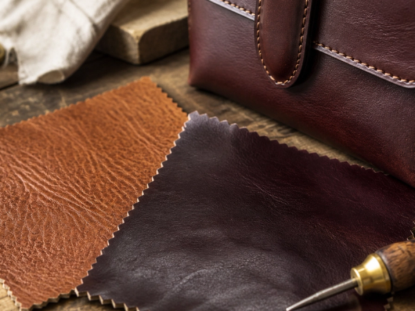 Leather grain and edge construction beside a luxury accessory