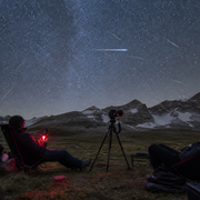 Dark-sky camp prepared for the 2026 Perseid meteor shower with chairs, red light and camera tripod