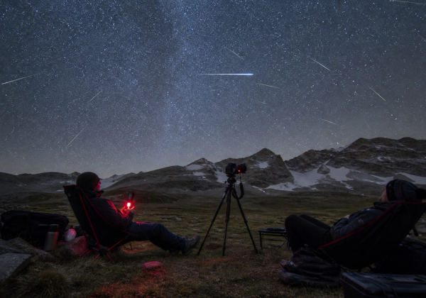 Dark-sky camp prepared for the 2026 Perseid meteor shower with chairs, red light and camera tripod