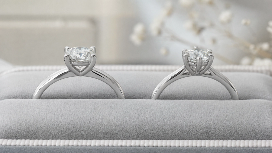 Four-prong and six-prong solitaire engagement-ring profiles on jeweller trays