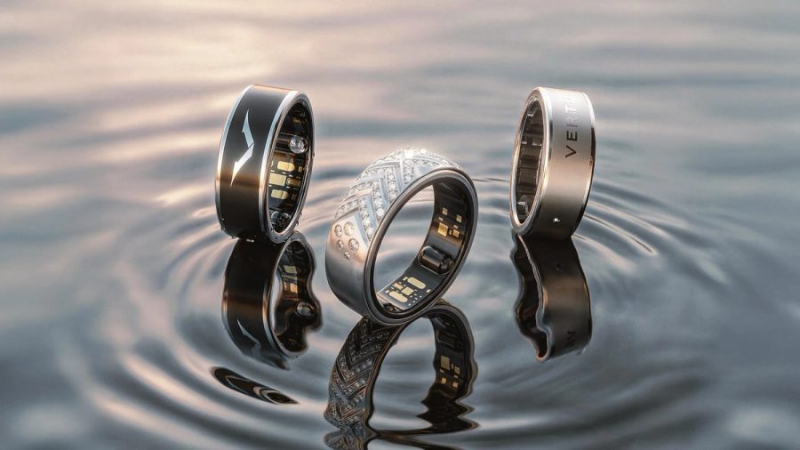 Three VERTU AI Aura Rings on water — black, diamond pavé, and silver — official product photography for the Care Five-Piece Set