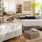 Two buyers testing mattress support beside natural-fibre construction samples
