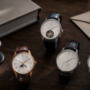 Four high-end complicated watches examined beside an auction catalogue and service records