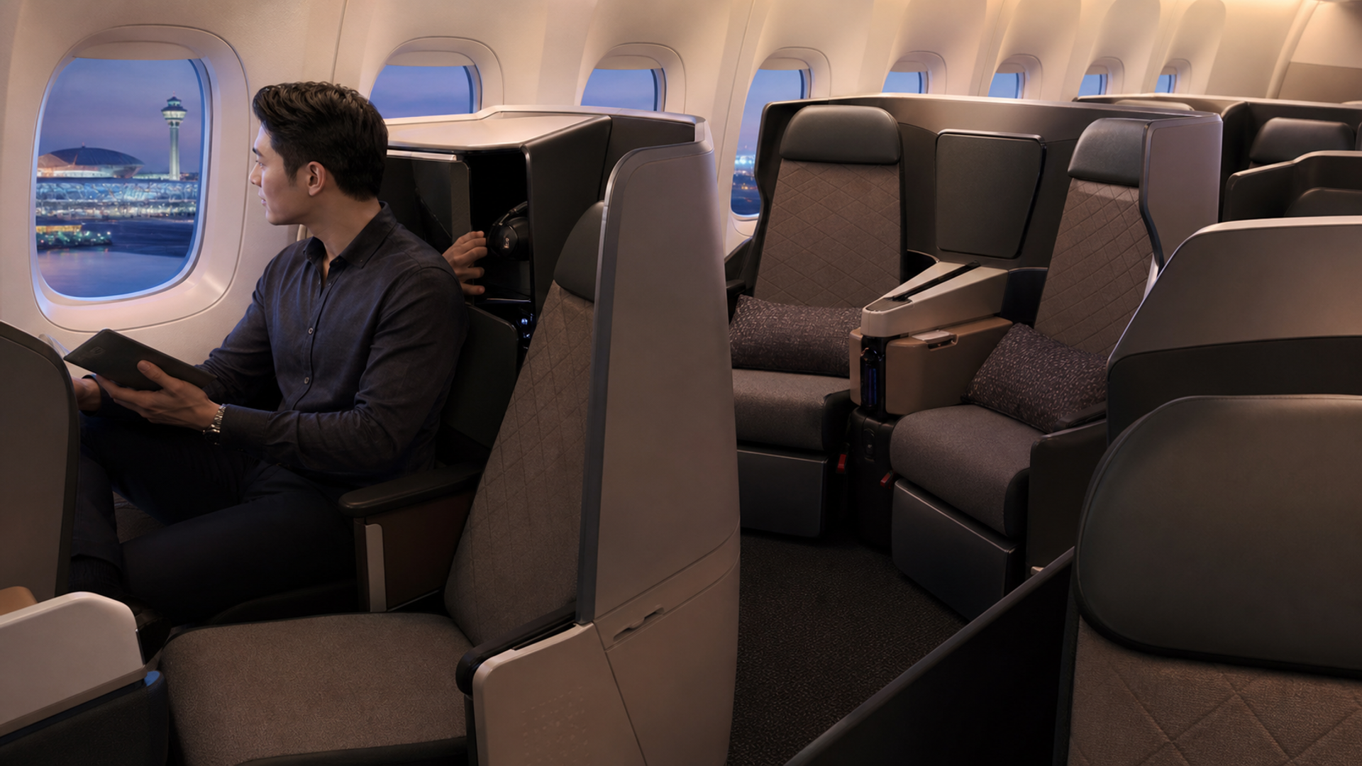 Traveller comparing direct-aisle seat types in a next-generation business-class cabin
