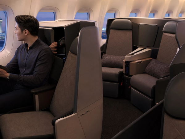 Traveller comparing direct-aisle seat types in a next-generation business-class cabin