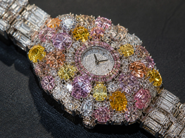 Macro view of a high-jewellery bracelet watch set with many fancy-colour diamonds