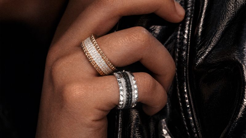 A woman's hand with a stylish smart ring, interacting with a tablet.