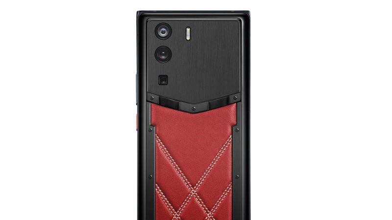 A luxury VERTU phone with a unique design, held elegantly.