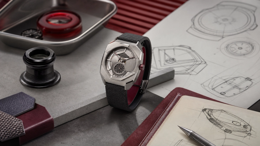 Contemporary geometric wristwatch displayed beside a loupe, sketchbook and collector evaluation card