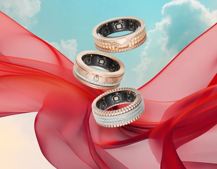 A close-up of a luxury smart ring being worn, showing its sleek design and material finish.
