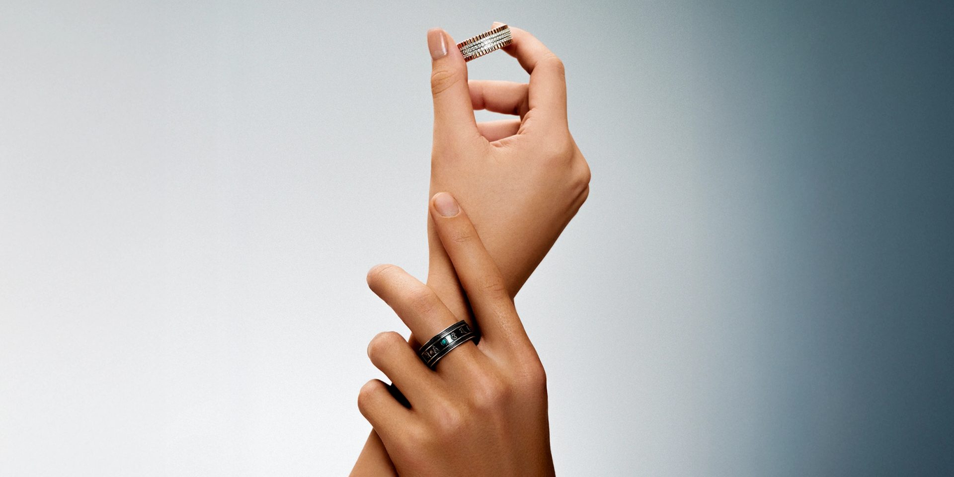 A close-up of a sophisticated smart ring being worn on a finger.