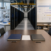AI research organisation leadership handover connecting a boardroom, laboratory and compute team