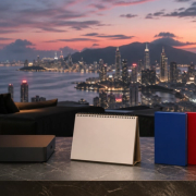 Premium gaming lounge overlooking a fictional coastal city with a blank calendar and three edition cases