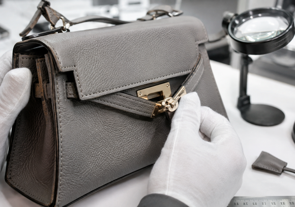 Designer handbag inspected with magnification for construction, hardware and authenticity evidence