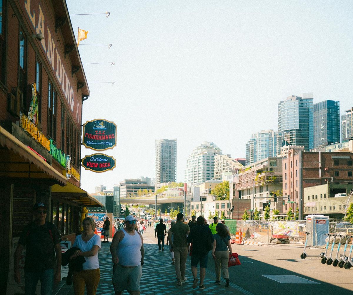 Crowded Seattle street with urban city skyline and vibrant pedestrians.