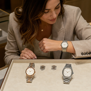 A woman comparing the wrist fit and profiles of three distinct high-end watches