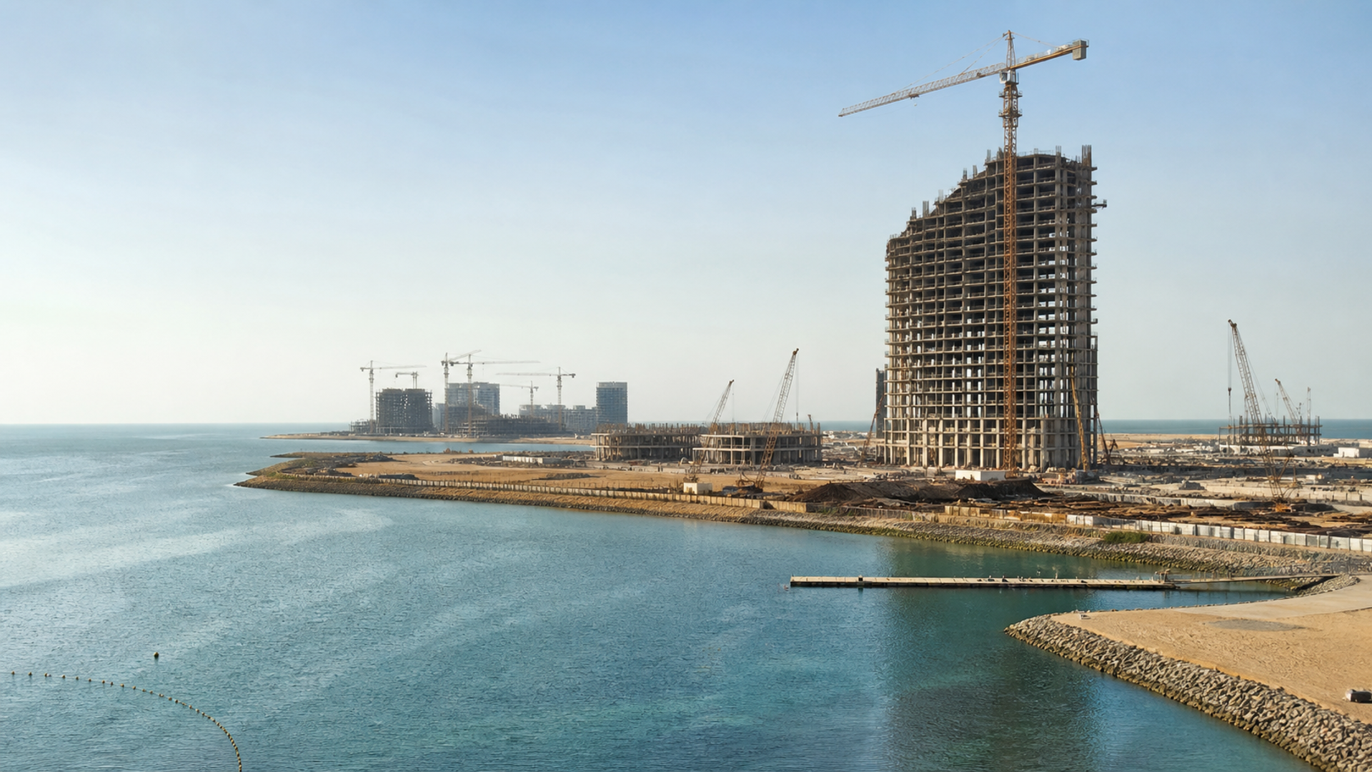 editorial coastal photograph of Al Marjan Island in Ras Al Khaimah with a major resort tower visibly under construction