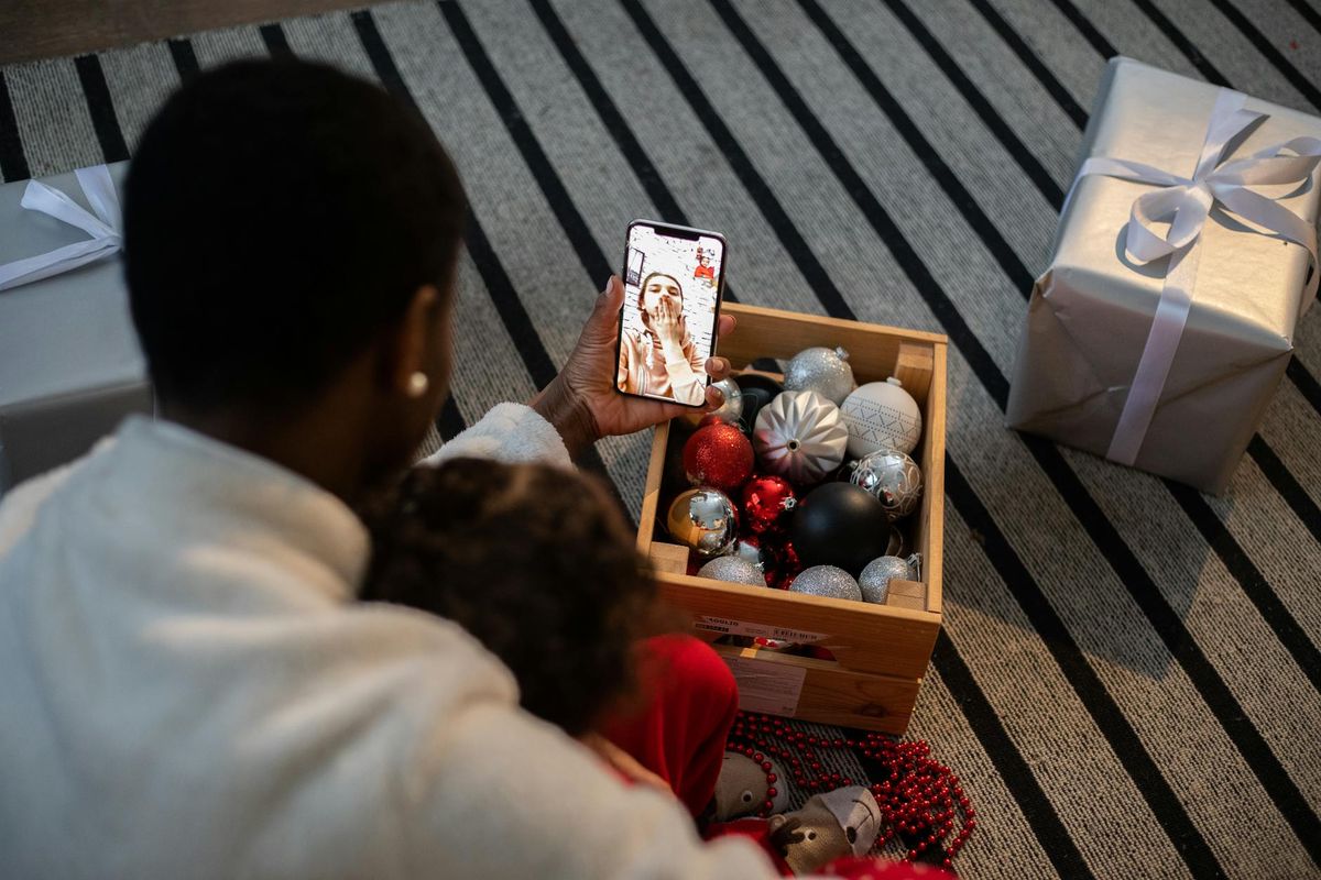 A family connecting via video call during a Christmas celebration, sharing festive moments online.