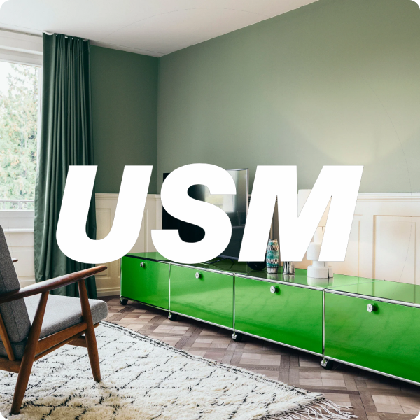 USM furniture in a green interior with the USM wordmark