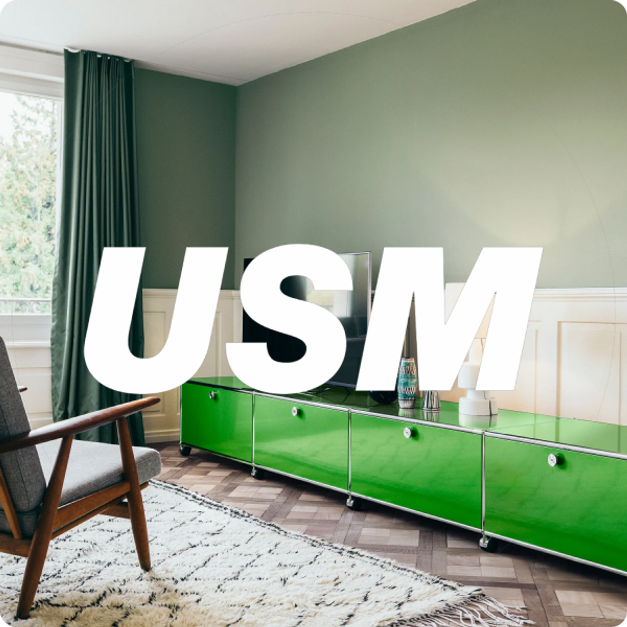 USM furniture in a green interior with the USM wordmark