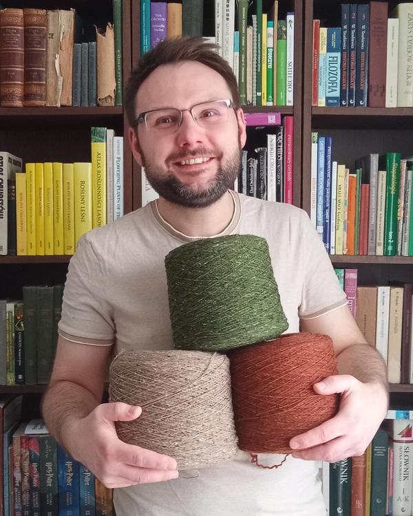 Picture displays a person who weaves the carpet