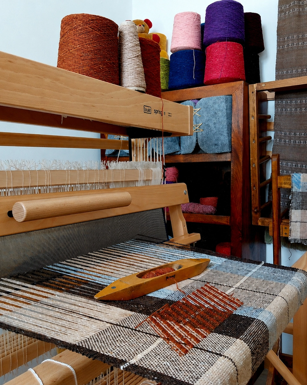 Home weaving studio with a Louët multi-shaft loom. Handwoven scarves, cushion covers and textiles created from Irish Donegal wool using traditional weaving techniques