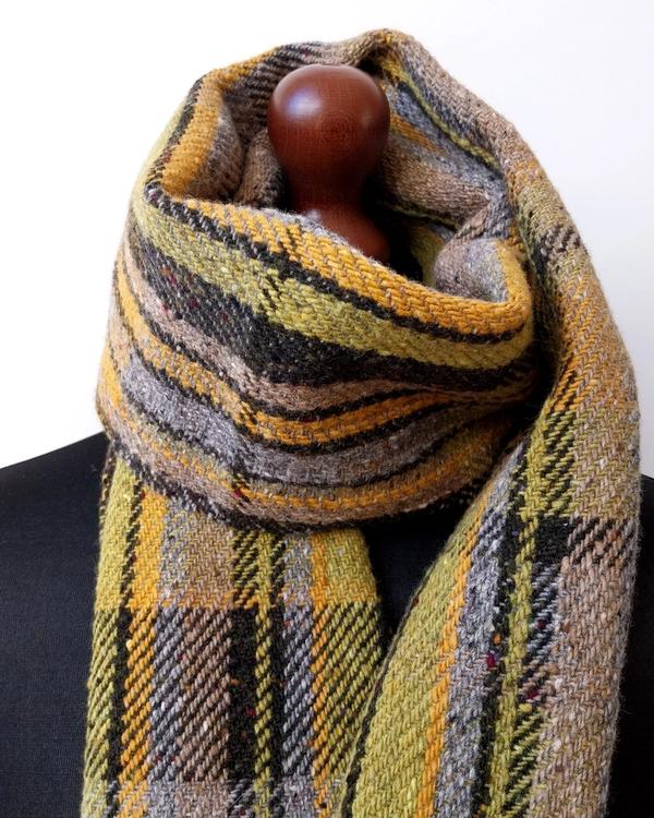 Handwoven merino scarf with olive, yellow, grey and brown stripes, created using a random colour sequencing process and traditional weaving techniques