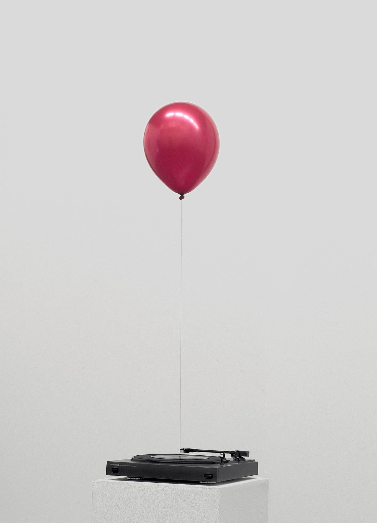 Davide Balula, Un air de fête, 2004, platine vinyle modifiée, disque vinyle 45T, ballon rouge, fil, collection Frac Champagne-Ardenne, Reims. © Davide Balula, Frac Champagne-Ardenne