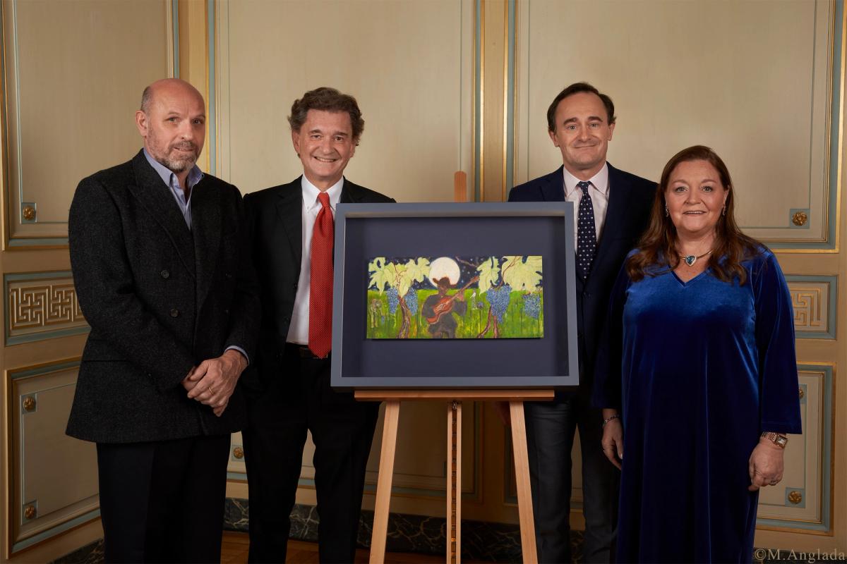 De gauche à droite : Peter Doig, Philippe Sereys de Rothschild, Julien de Beaumarchais de Rothschild, Camille Sereys de Rothschild, autour de l'œuvre originale créée pour le Château Mouton Rothschild. © M. Anglada.