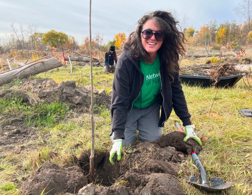 An ecologist digging a hole.