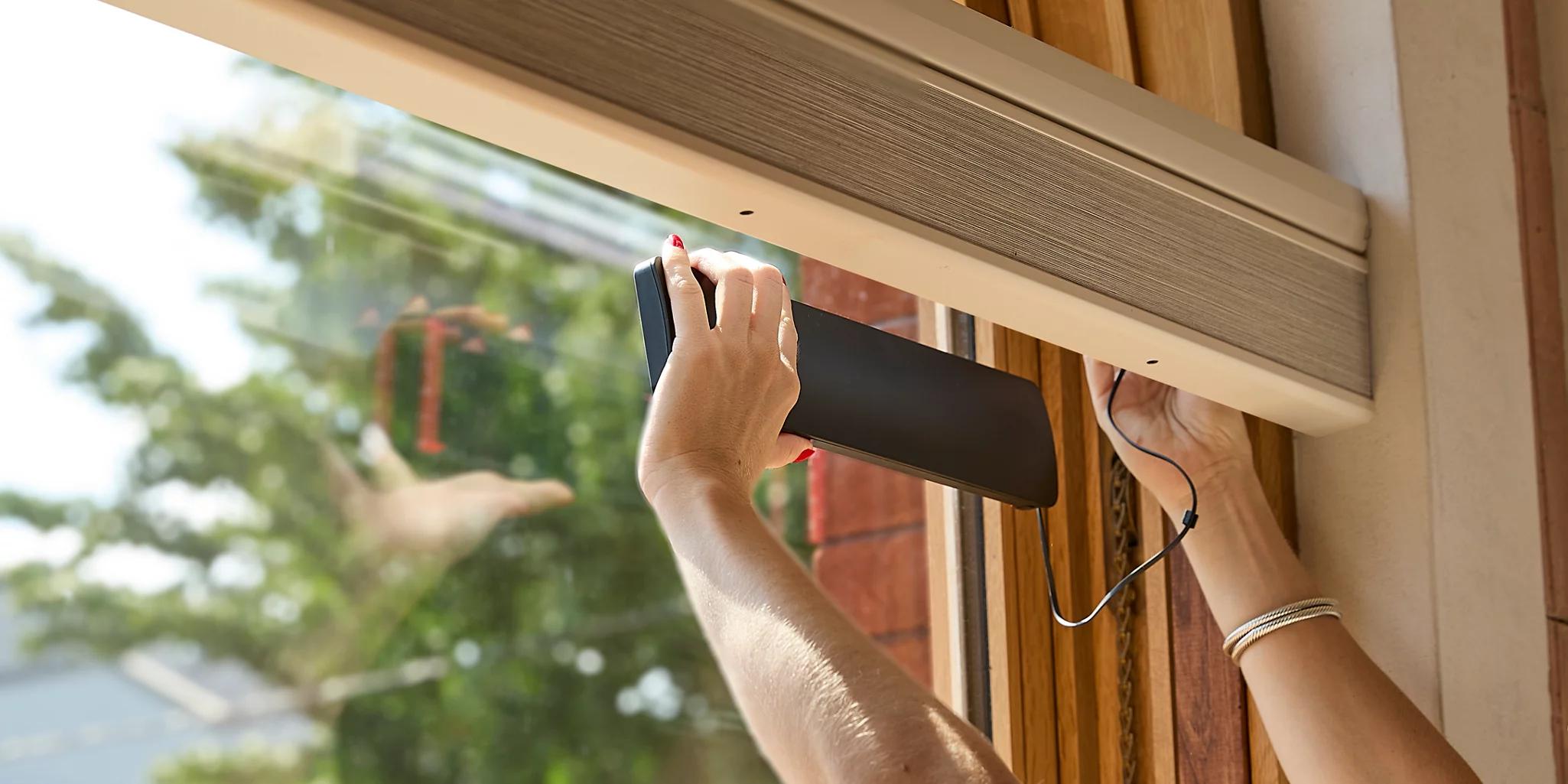 PowerView Solar Charger being installed on window