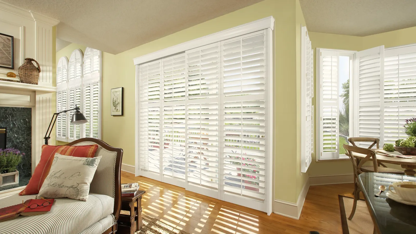 White plantation shutters in a bright bedroom