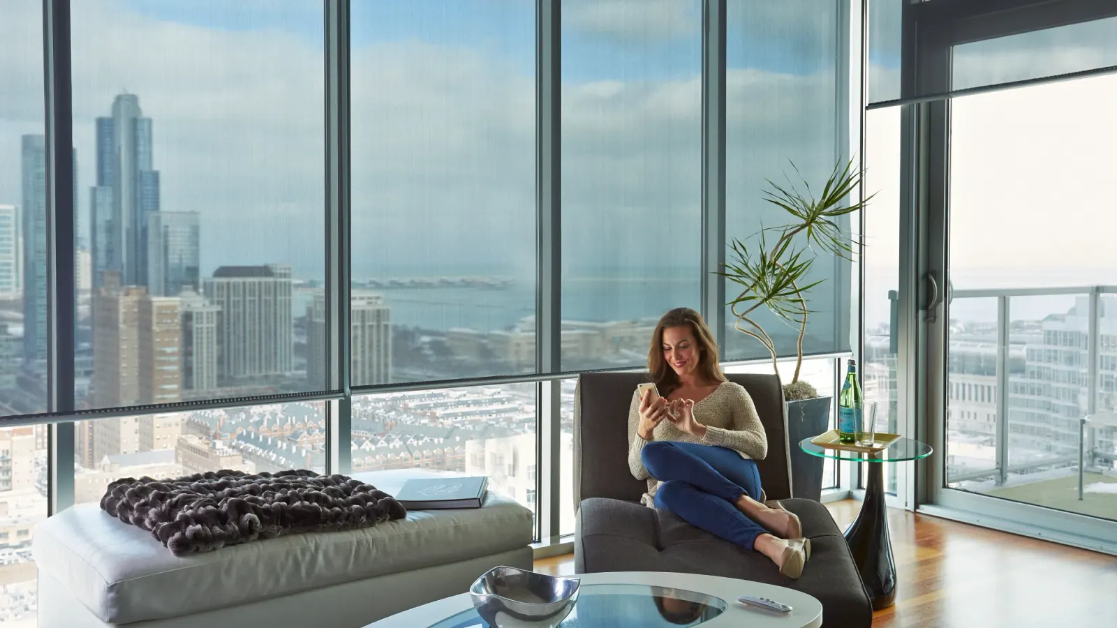 Motorized solar shades lowering in a living room