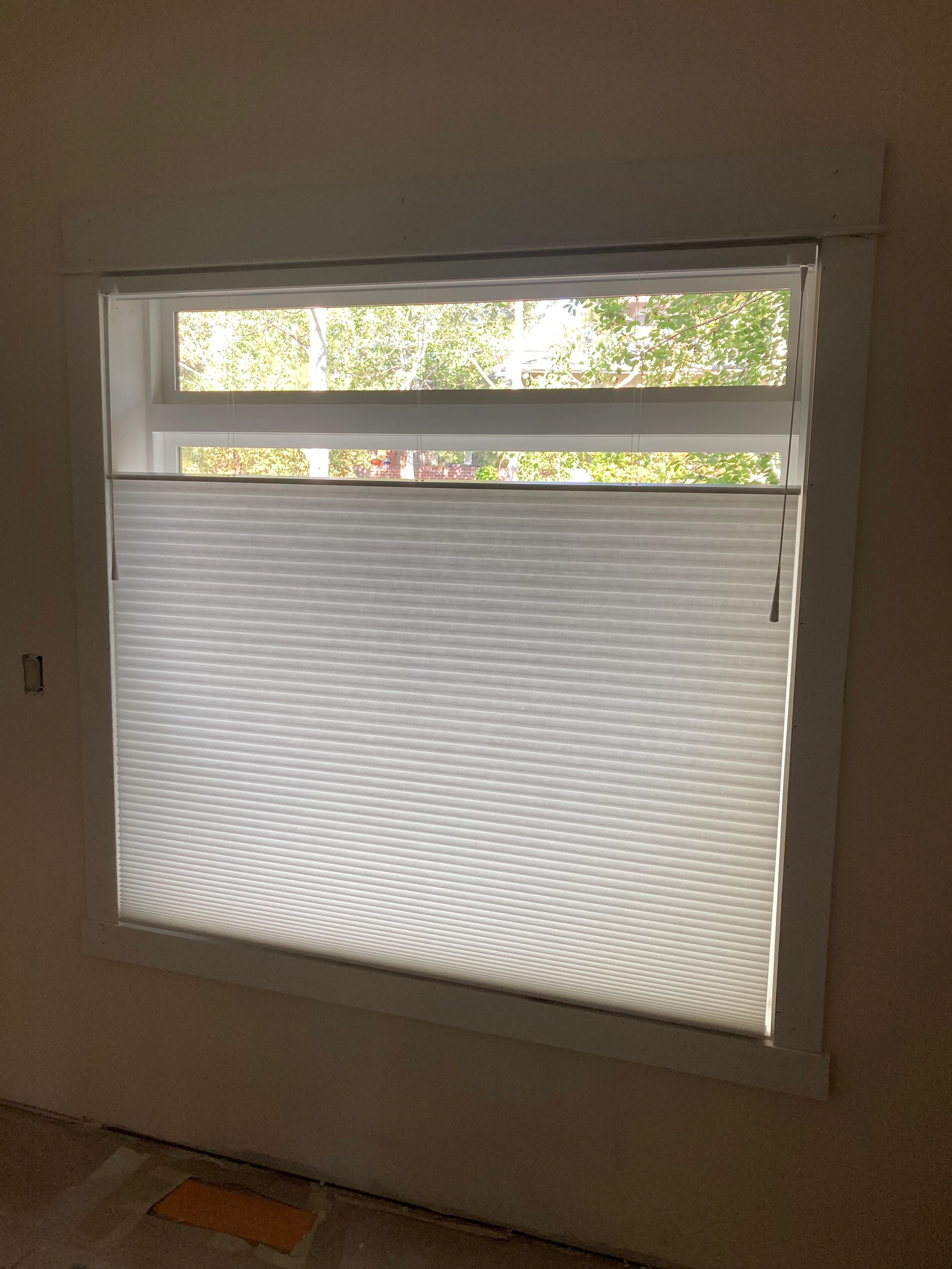 A window with Hunter Douglas shades.