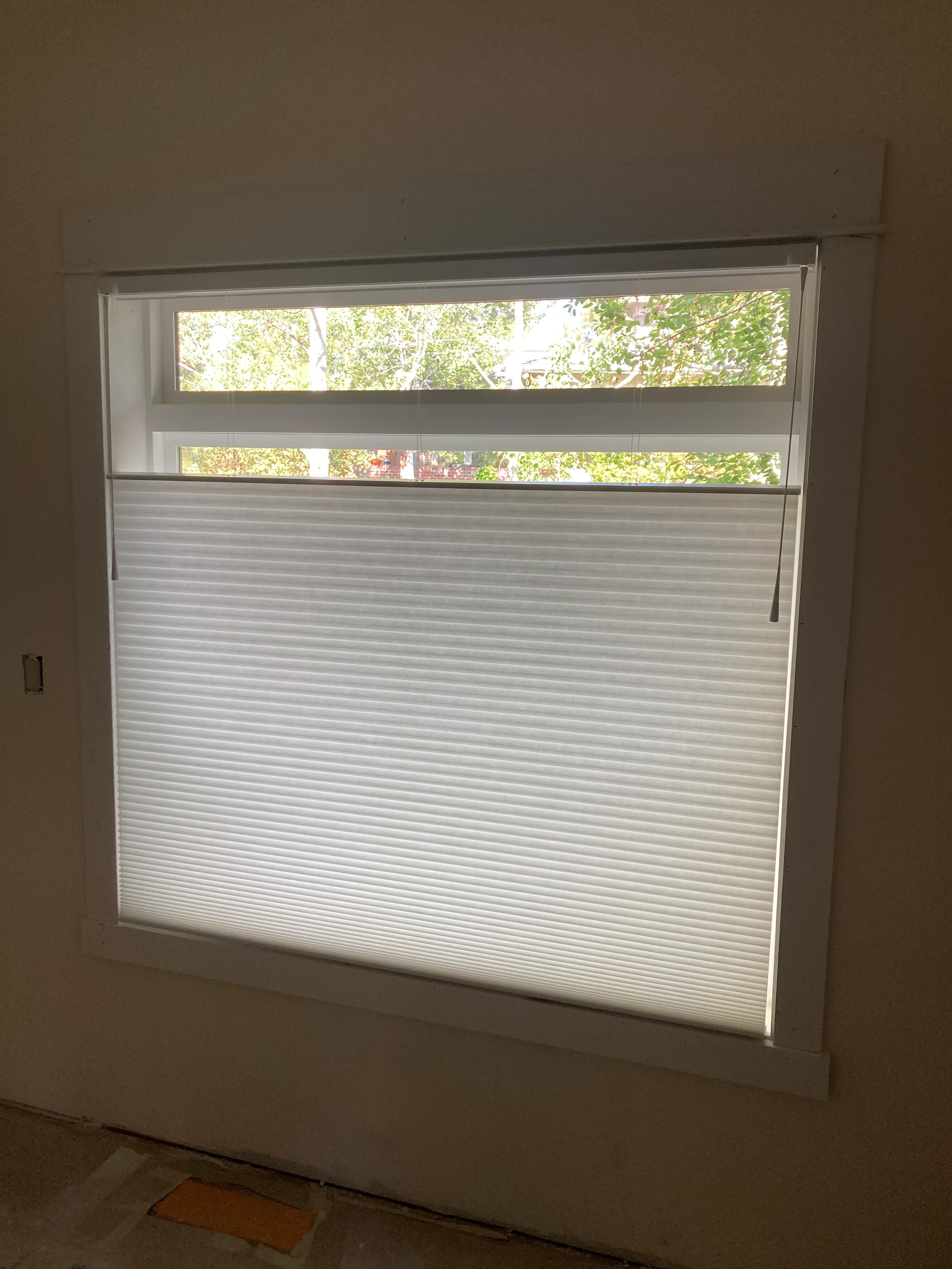 A window with Hunter Douglas shades.