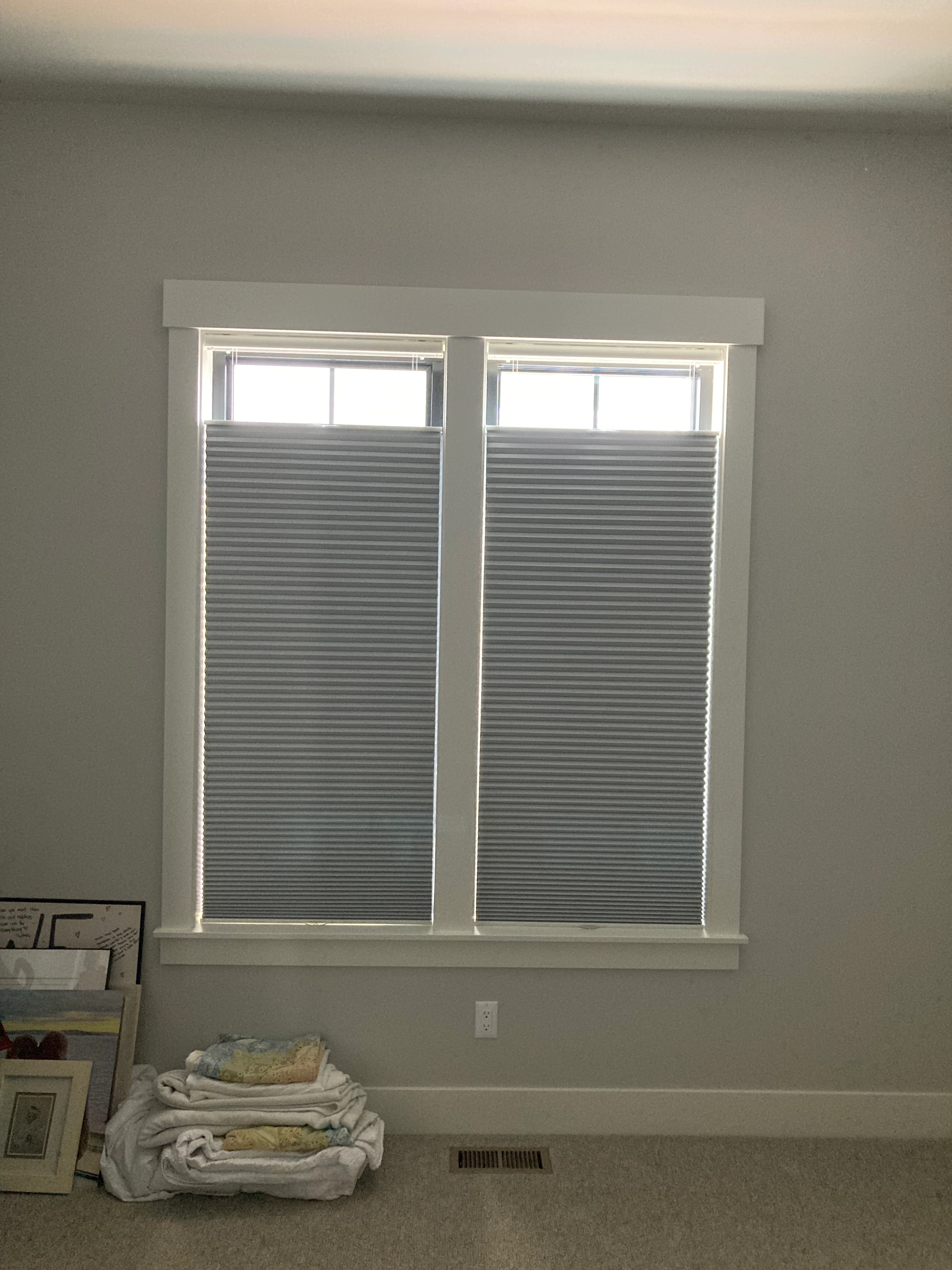 A window with Hunter Douglas shades.