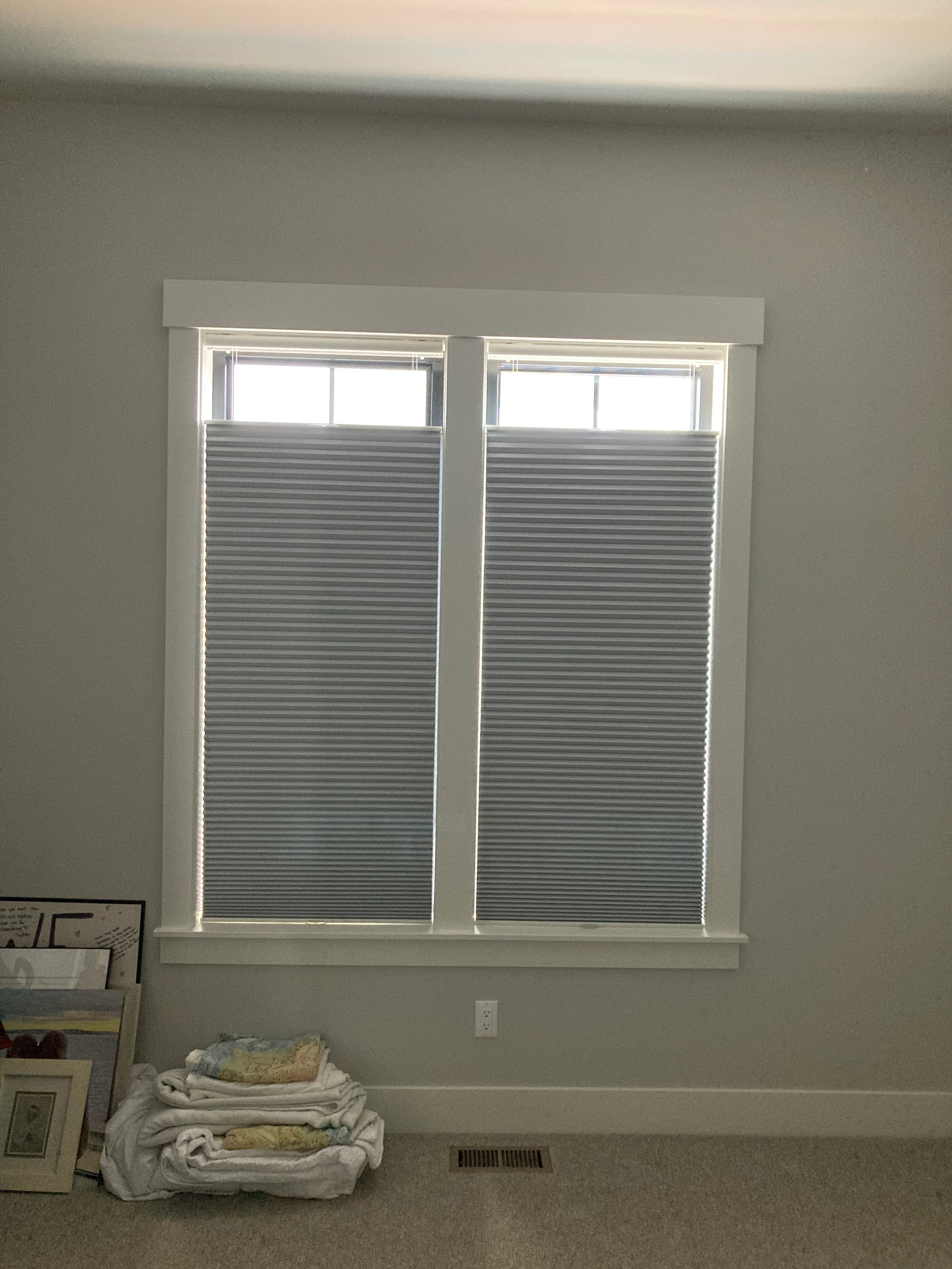 A window with Hunter Douglas shades.