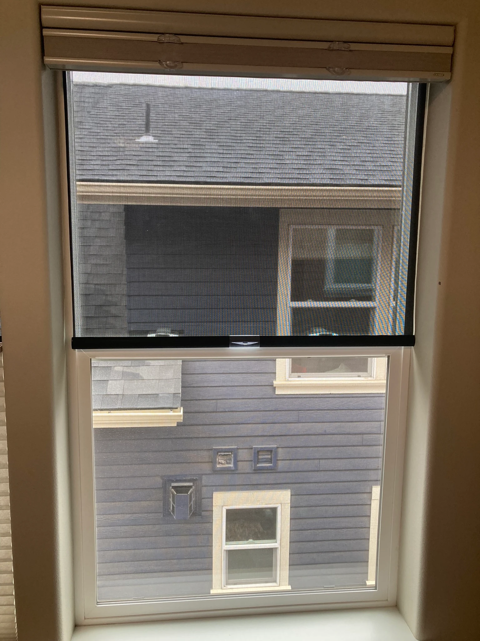 A window with Hunter Douglas shades.