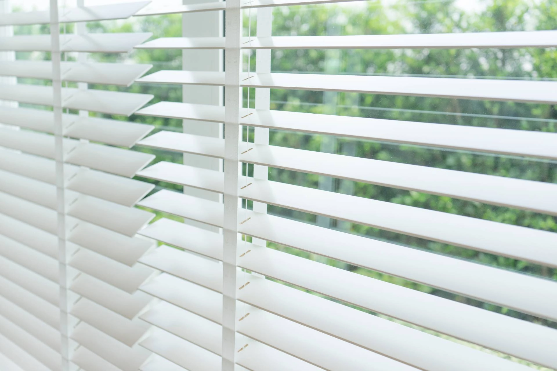 White push-up blinds covering a window in a Tucson, AZ, home.
