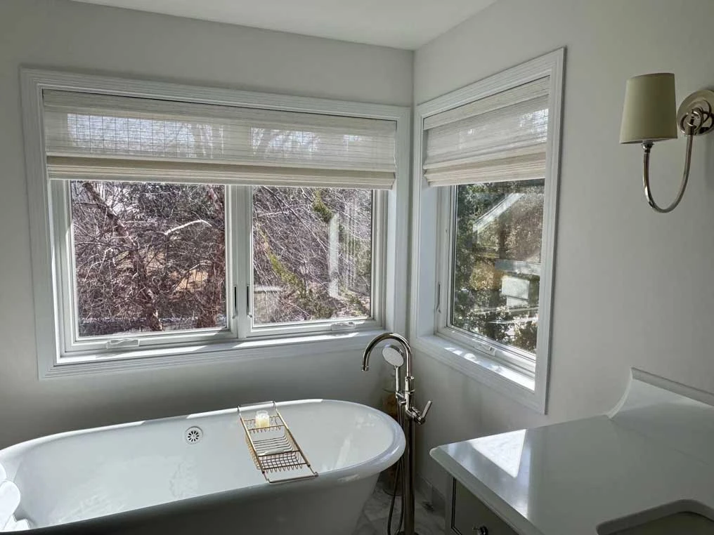 Bathroom windows with Hunter Douglas shades.