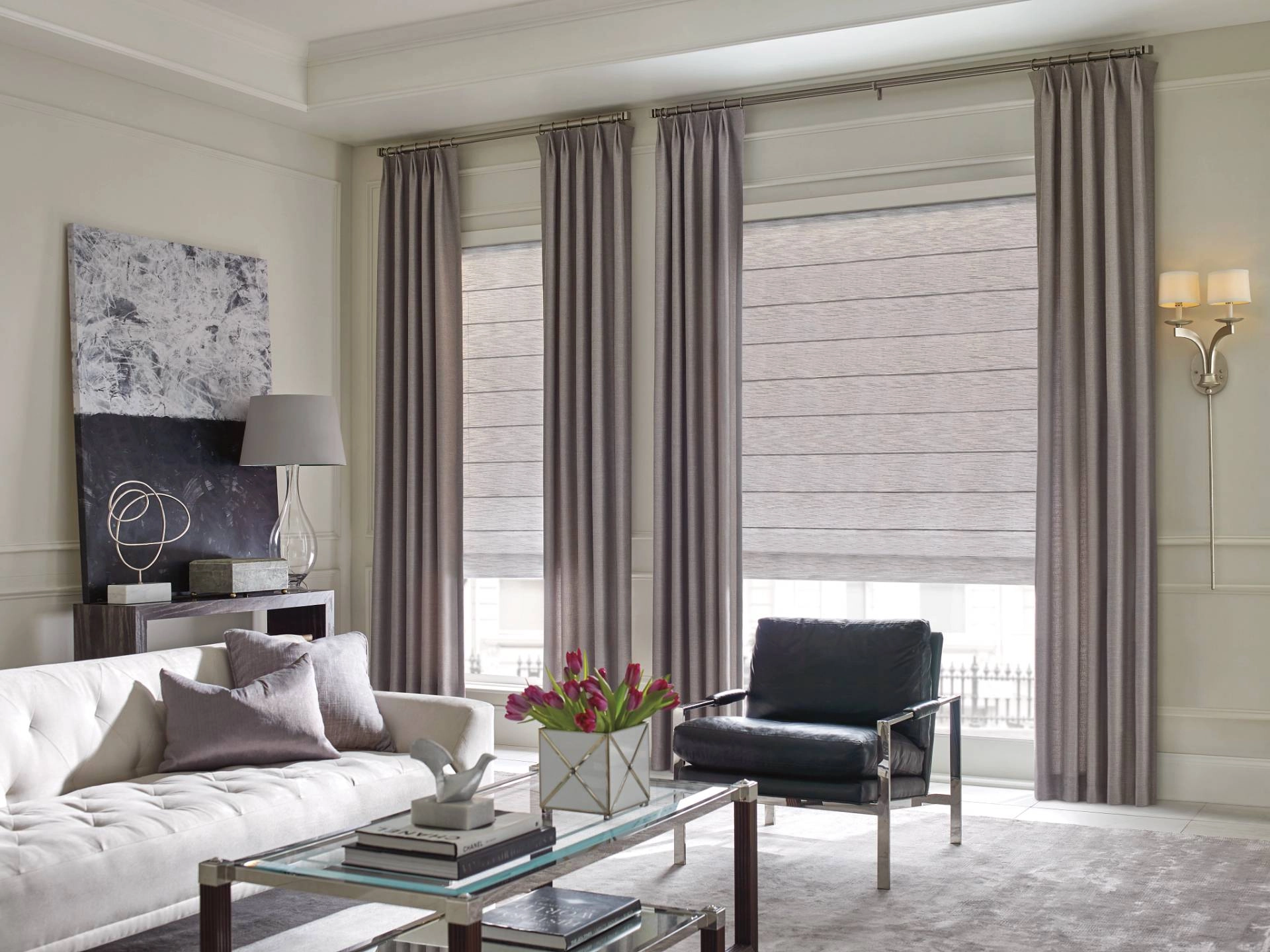 Woven Roman shades paired with drapery in a chic contemporary living room.