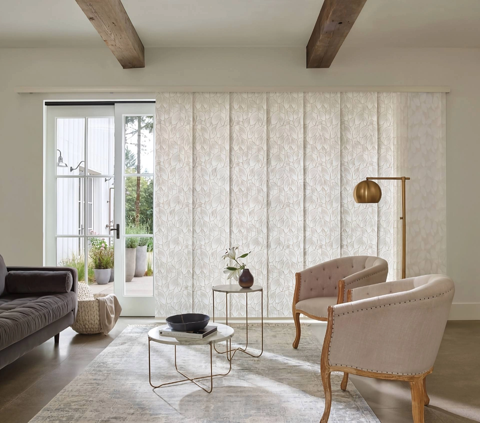 Hunter Douglas Skyline® Panel-Track Blinds on a large sliding glass door in a chic living room