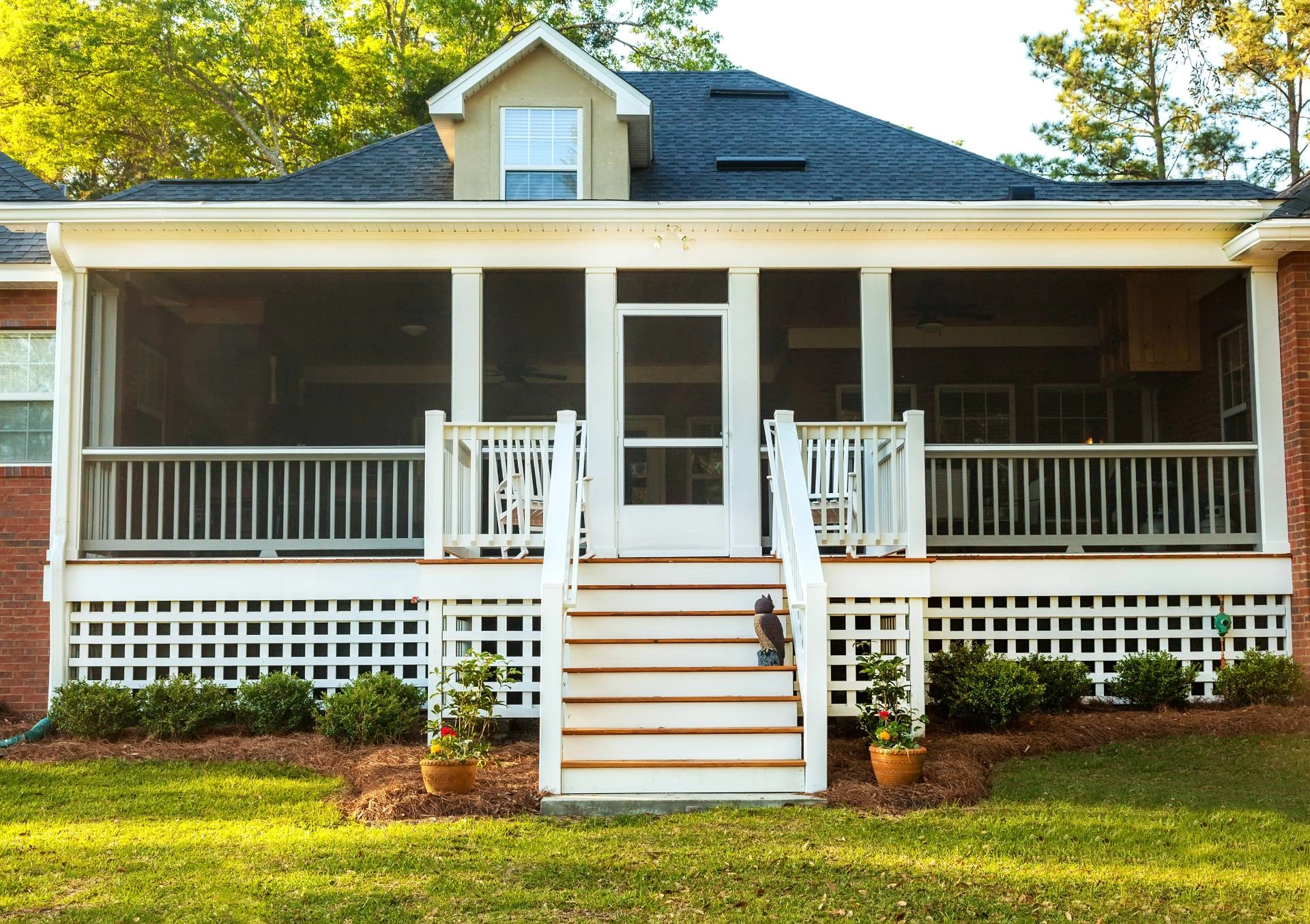 A home's front porch with retractable screens, making it easy to enjoy the outdoors near Hayden, ID