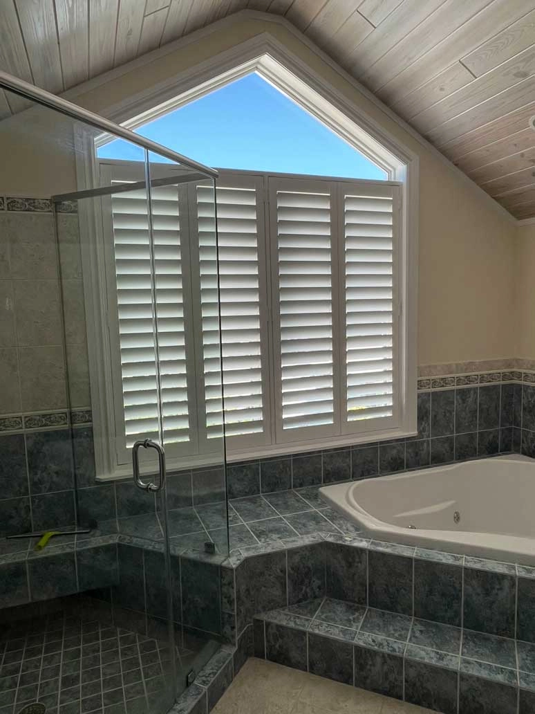 Shutters above a bath tub.