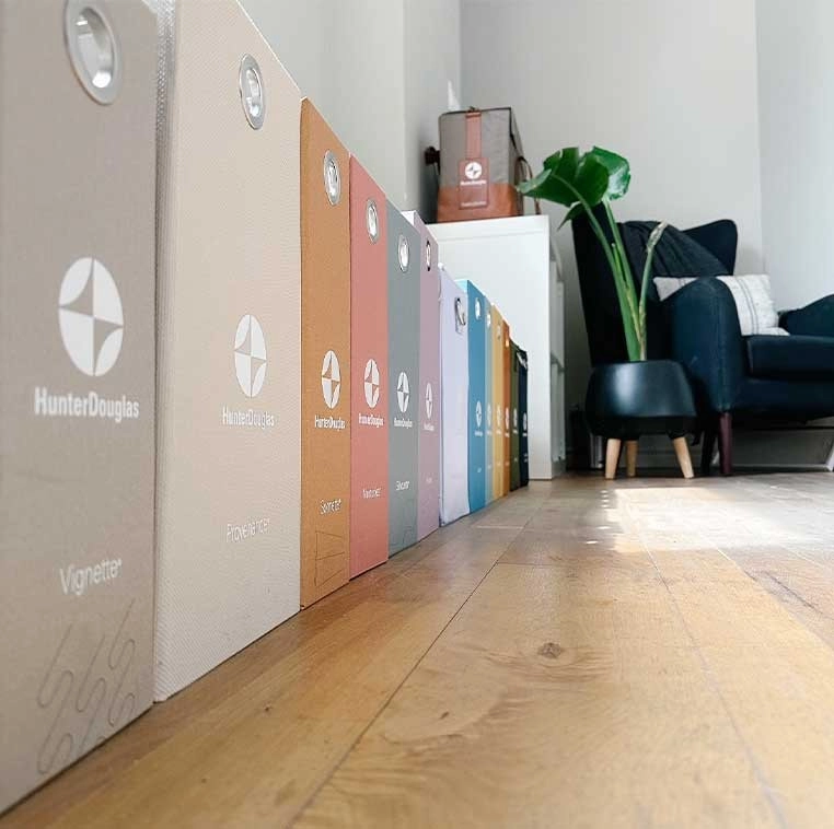A row of multi-colored Hunter Douglas branded cases