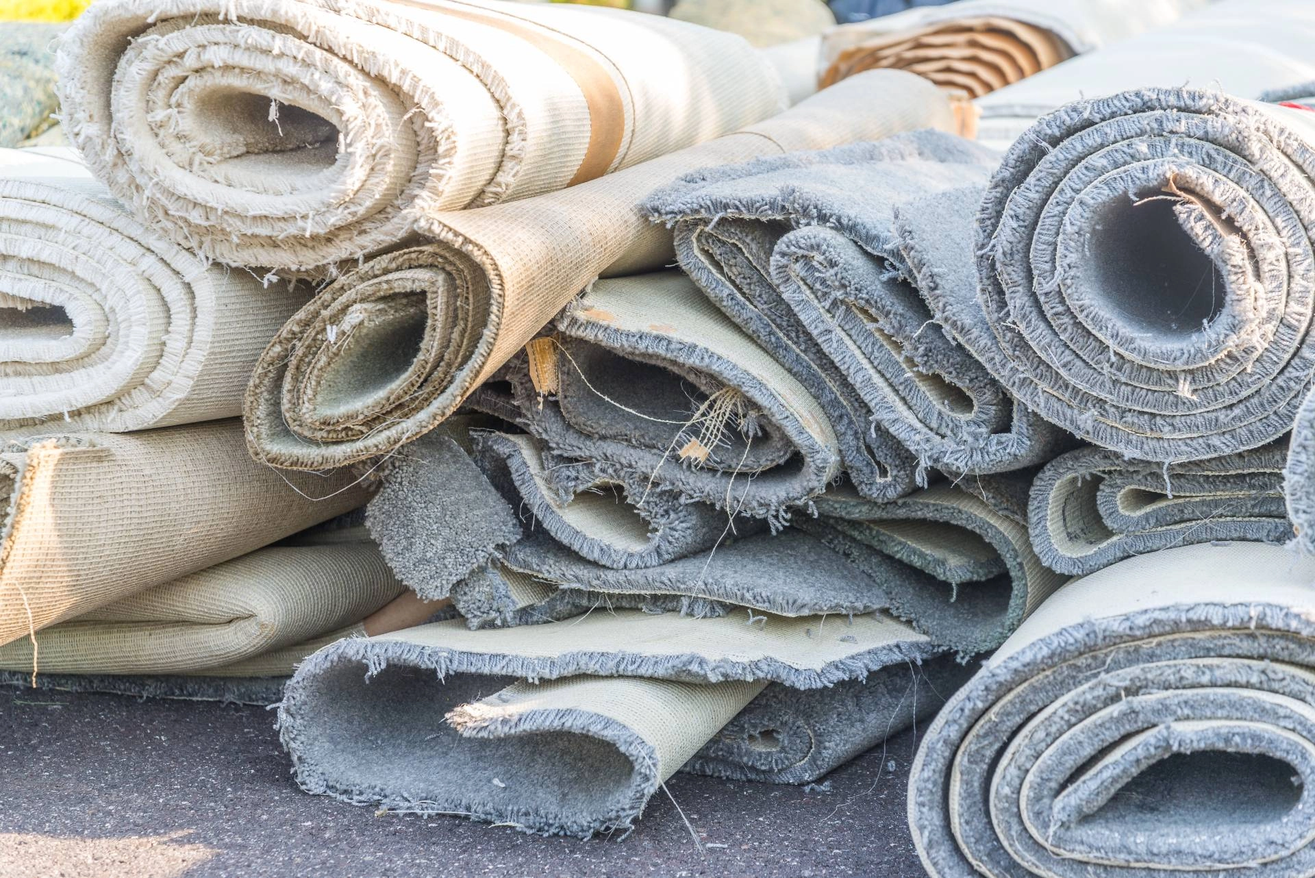 Rolls of old carpet in a pile outside a home near Los Angeles, CA.