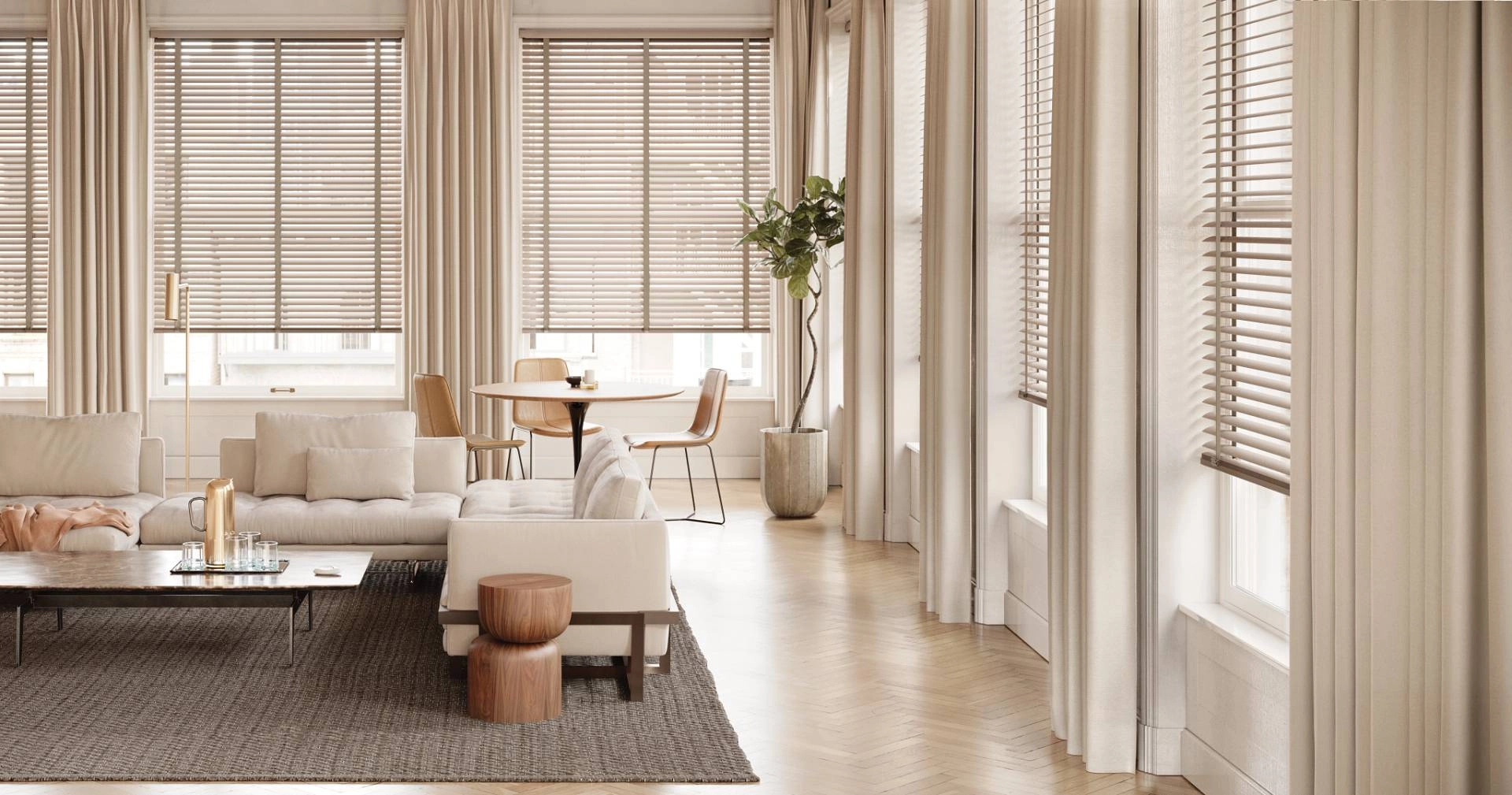 Living room with a beige sectional, furniture, and wooden modern blinds near Saint George, UT